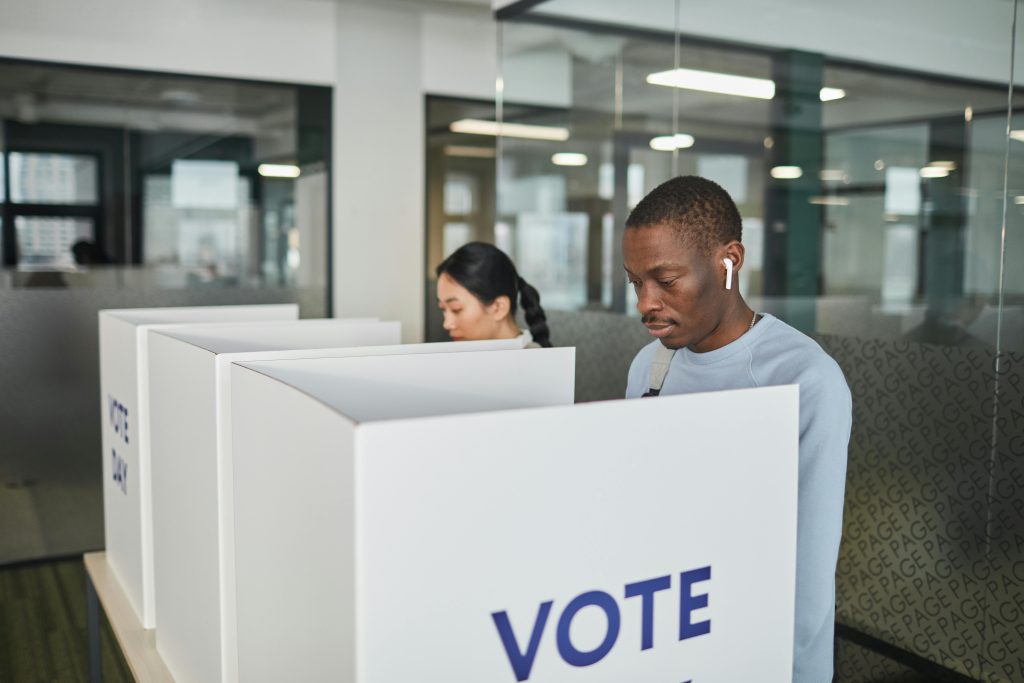 people voting at a booth